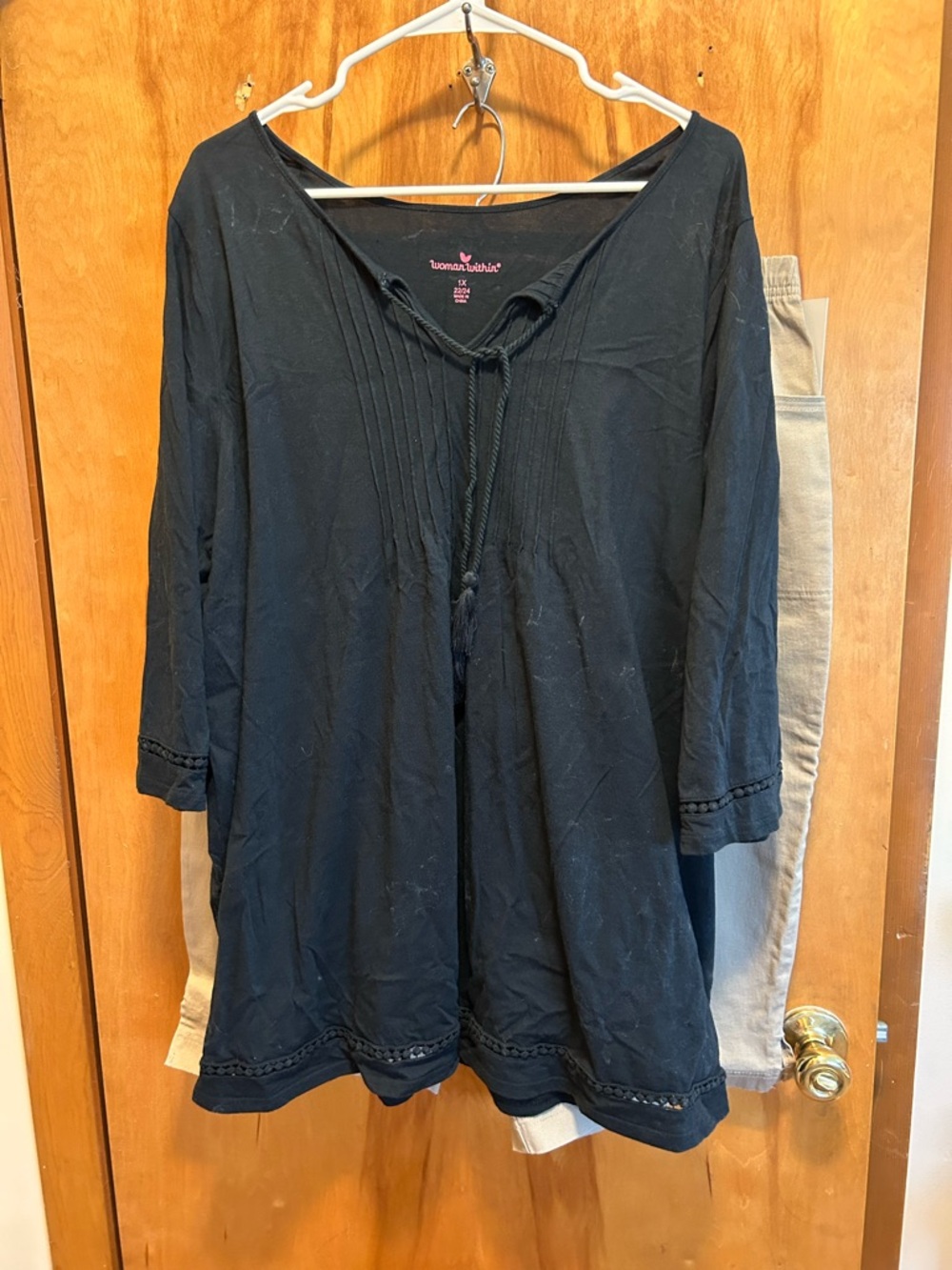 women's black tunic top and khaki capris